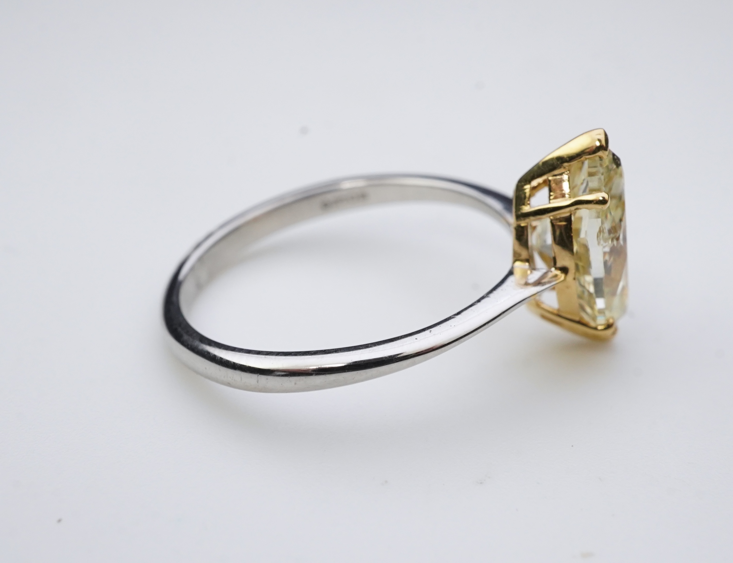 A yellow diamond solitaire ring